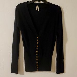 women's black sweater with brass snap buttons